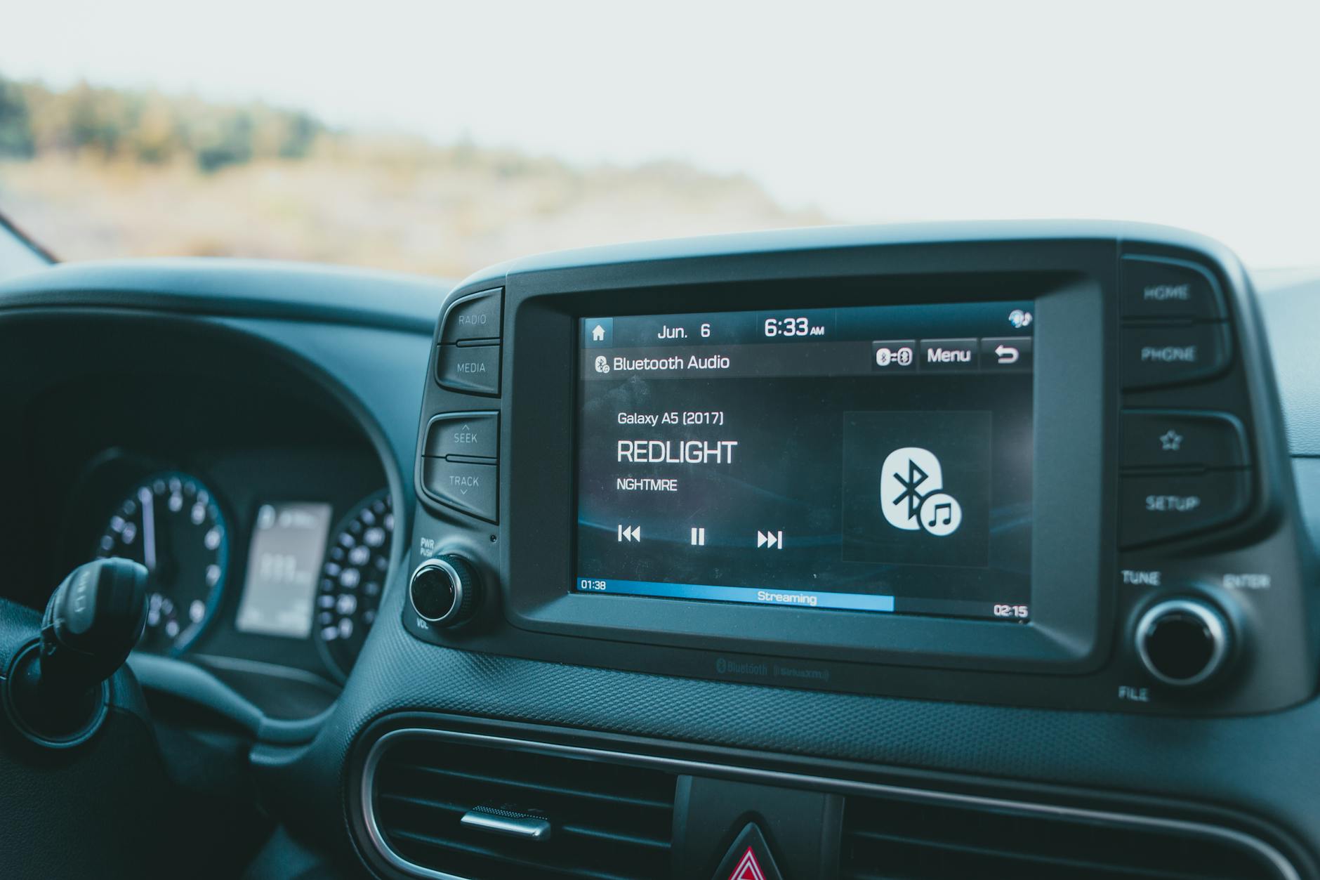 Zbliżenie na ekran systemu audio z Bluetooth na desce rozdzielczej Mazdy
